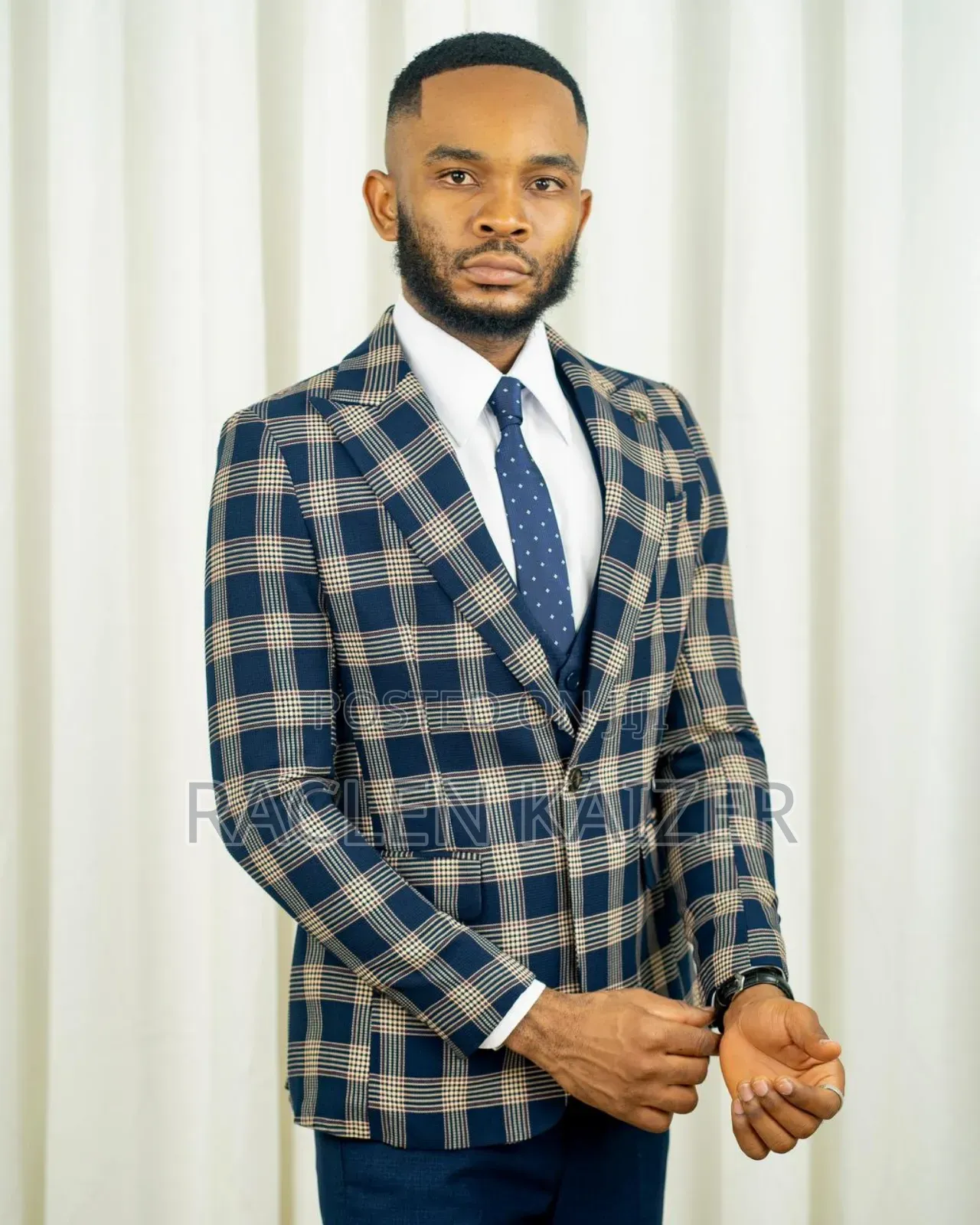 A Navy Suit With Beige Checkered Jacket, Vest, and Navy Trousers