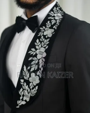 A Black Jacket Suits With Velvet Lapels Adorned With White Embroidery