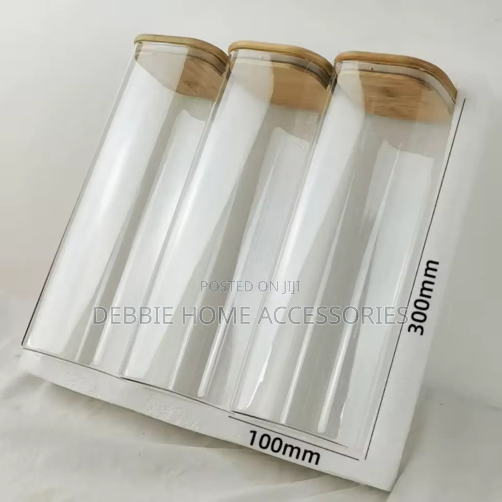 Three Glass Storage Jars With Bamboo Lids.