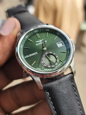 Domino Dm-4030g Watch, "Goldiebox" on the Watch Face a Green Dial