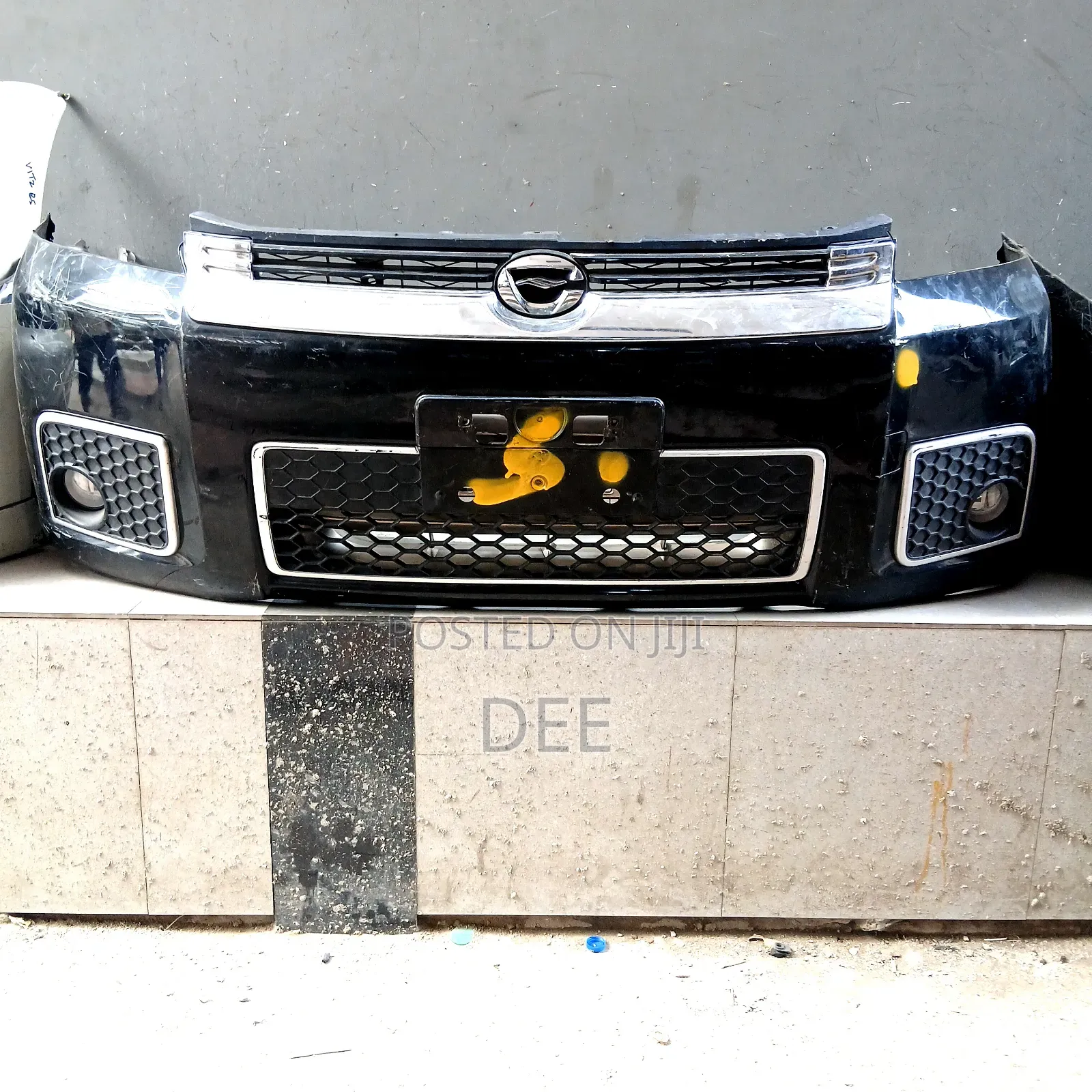 This Is a Black Front Bumper Assembly for a Toyota Corolla Rumion.