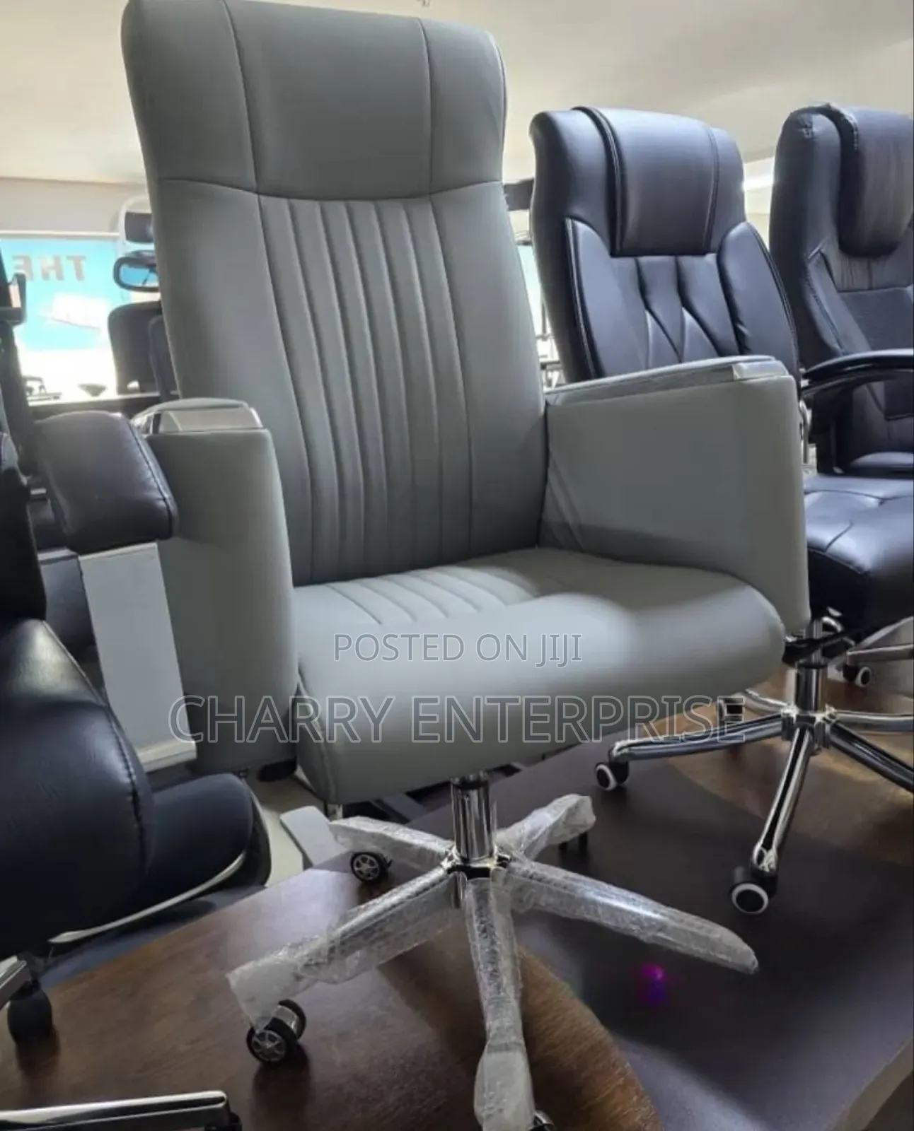 High-Back Executive Office Chair It Features a Chrome Base With Wheels