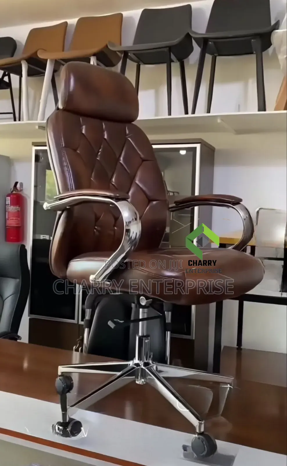 Leather Executive Office Chair With Chrome Arms and a Rolling Base.