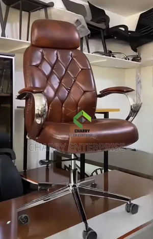 Leather Executive Office Chair With Chrome Arms and a Rolling Base.