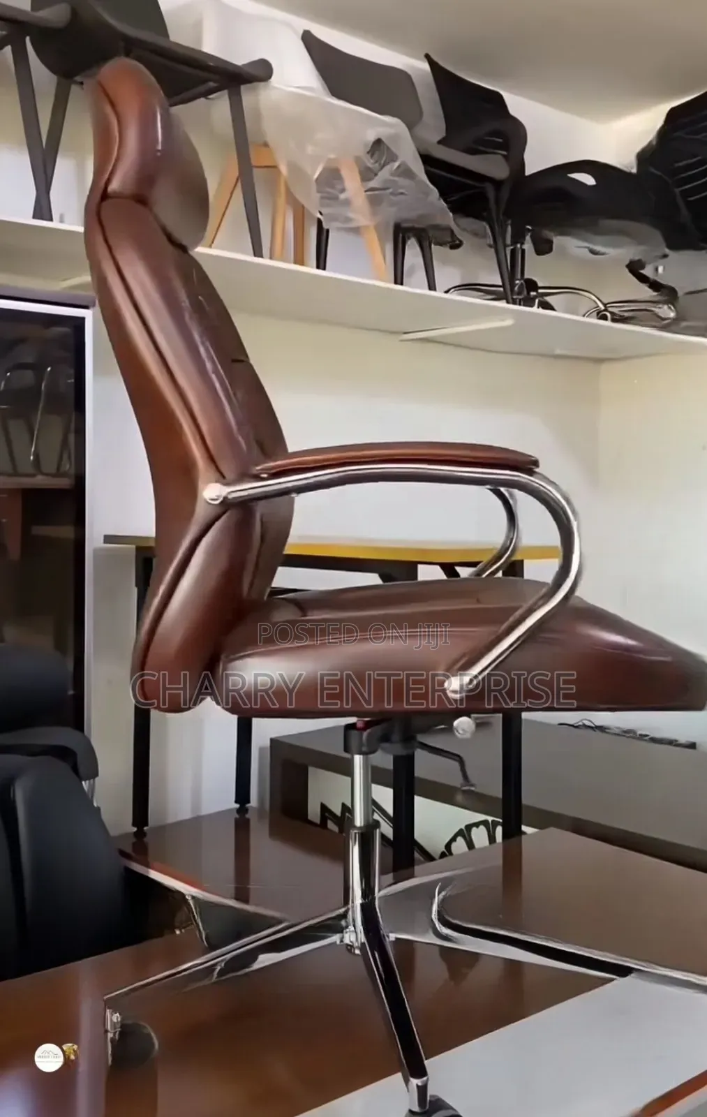 Leather Executive Office Chair With Chrome Arms and a Rolling Base.