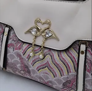 Chic Pink Patterned Handbag With Swan Claps