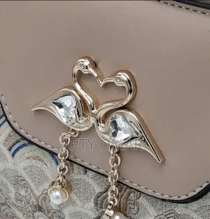 Chic Beige Patterned Handbag With Swan Claps