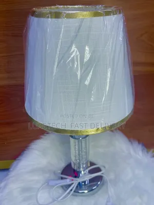 Bedside Lamp With a White Fabric Shade and a Clear Crystal-Style Base