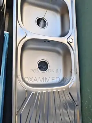 Stainless Steel Kitchen Sink That Features Double Bowls and a Single