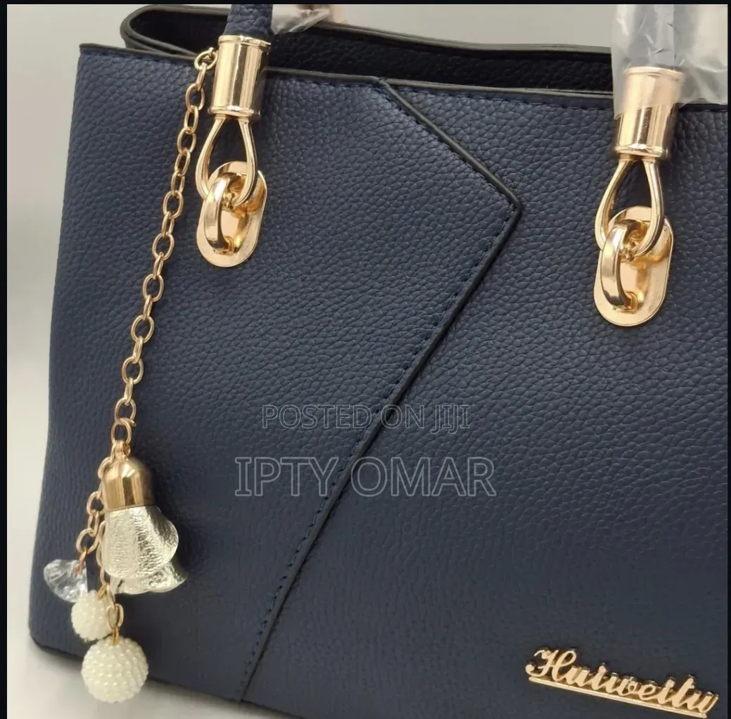 Navy Blue Handbag With Gold Accents and a Keychain