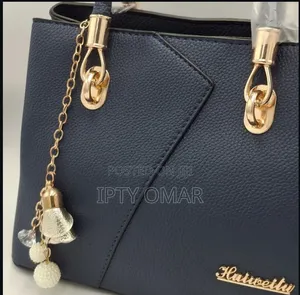 Navy Blue Handbag With Gold Accents and a Keychain